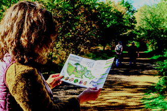 Walker holding a map of Lackford Lakes